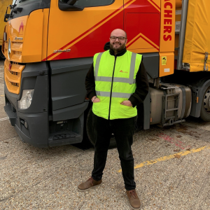 Darren Vale standing beside a Meachers truck