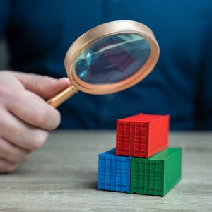 Containers being examined with a magnifying glass